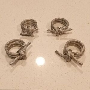 Set of 4 Nicole Miller napkin rings. Triple loop design tied in a knot NWOT